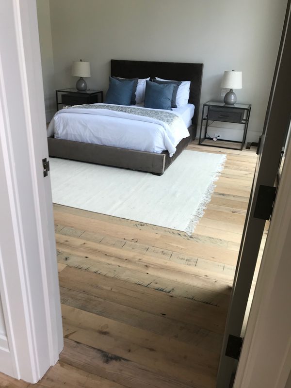 Bedroom with a wide-plank hardwood floor