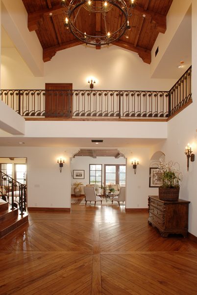 Two-storey entry hall with a balcony and hardwood floor
