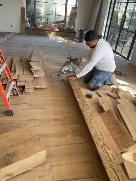 Cutting and fitting planks during install — Los Angeles, 2022