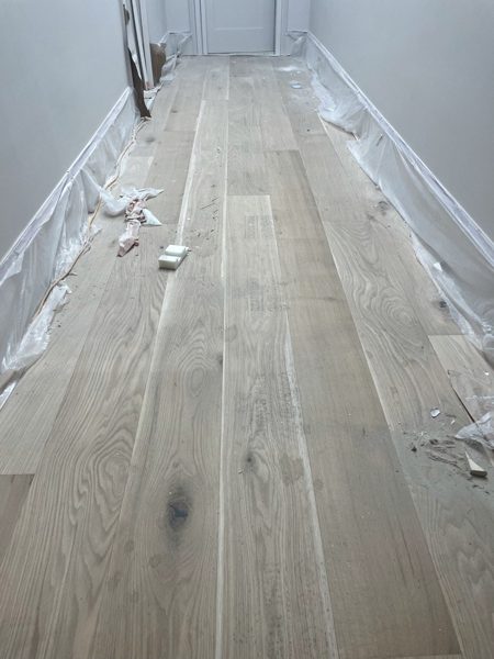 Wide-plank floor protected after install — Pacific Palisades, 2022